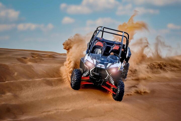 Experience the thrill of racing across golden dunes while enjoying stunning sunset views sandboarding adventures and delightful encounters with majestic camels. Embrace the spirit of Dubai’s desert!